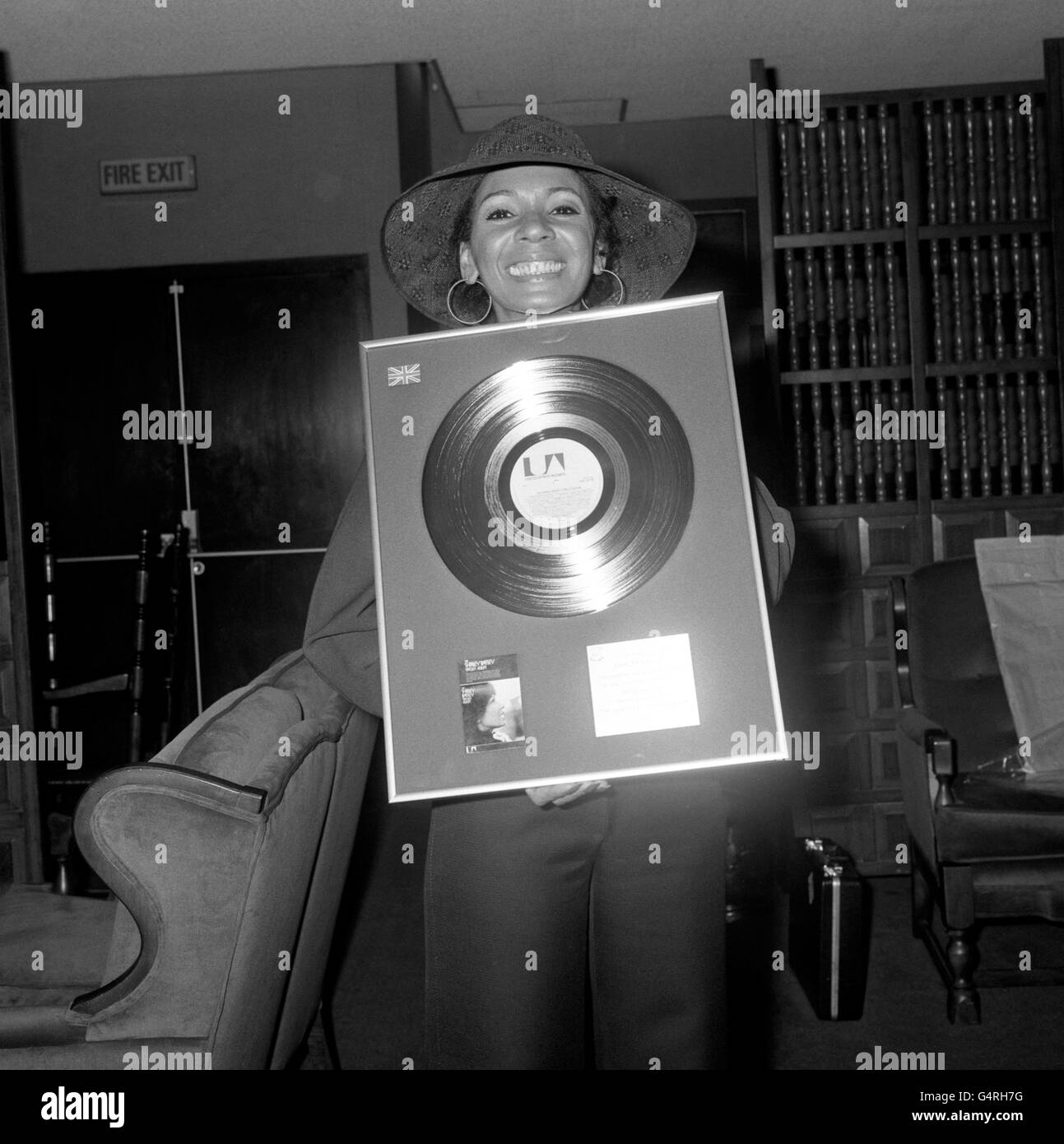 Singer Shirley Bassey with a gold disc awarded to her a for her record The Shirley Bassey Singles Album and presented to her at Heathrow Airport when she arrived from Rome. It is her first British gold disc though she has 16 from other countries. While back home she will be appearing on Top of the Pops singing her new song, 'Good Bad But Beautiful'. Stock Photo