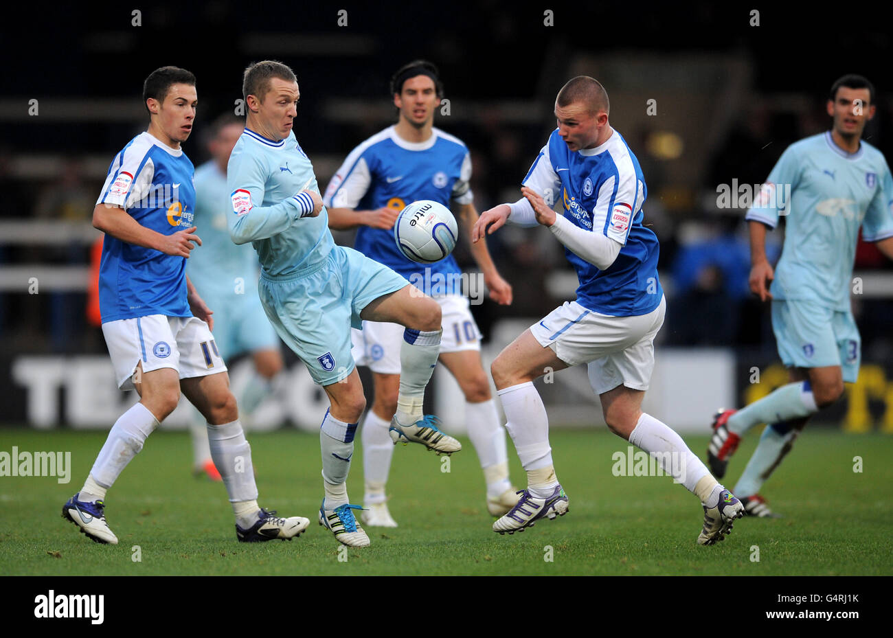 Soccer - npower Football League Championship - Peterborough United v Coventry City - London Road. Coventry City's Gary McSheffrey (2nd left) battles for the ball with Peterborough United's Ryan Tunnicliffe Stock Photo