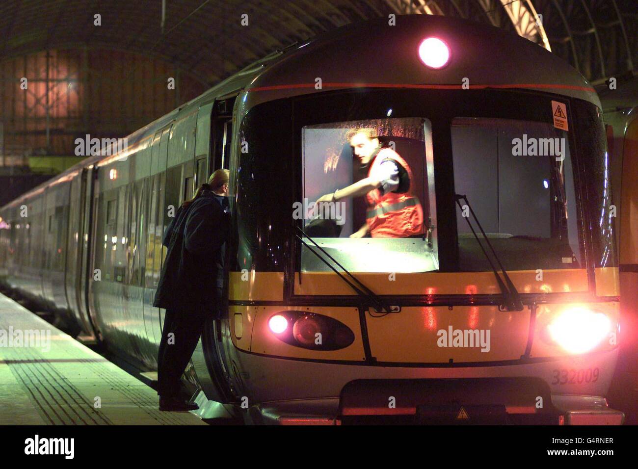 A driver checks the time on a Heathrow Express train, the first to run