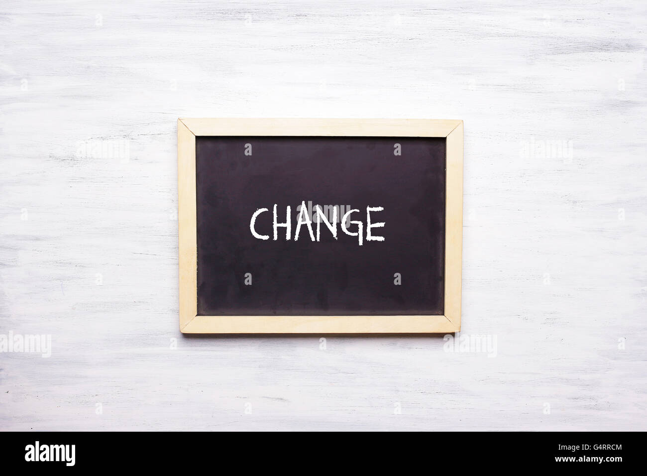 Top view of chalkboard with word CHANGE written on it. Motivation and leadership concept. Stock Photo