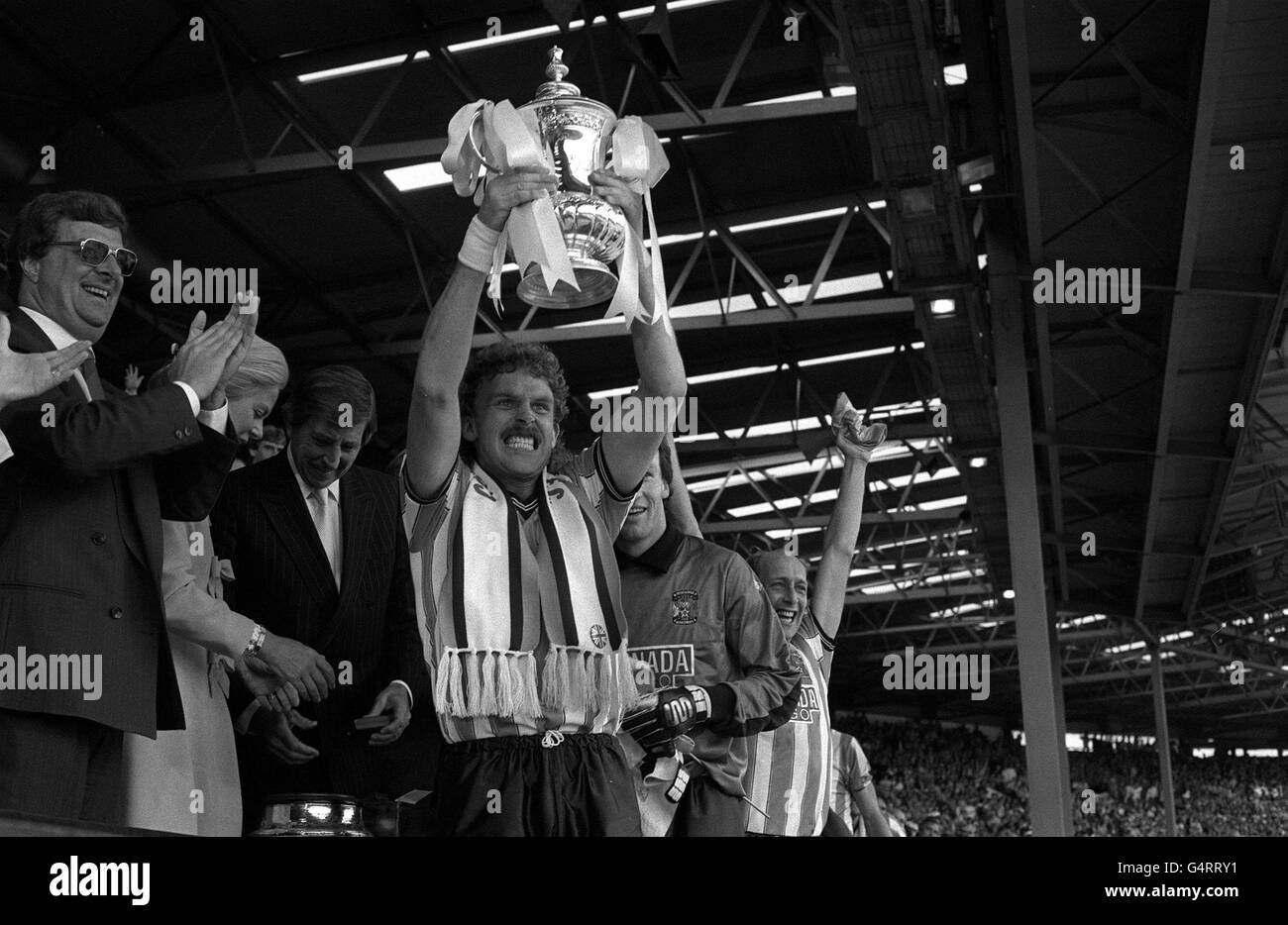 PA Photos 16.5.87 Triumphant Coventry City captain Brian Kilcline holds the coveted FA Cup football Trophy aloft after beating Tottenham Hotspur 3-2 in the Final, at Wembley in London Stock Photo