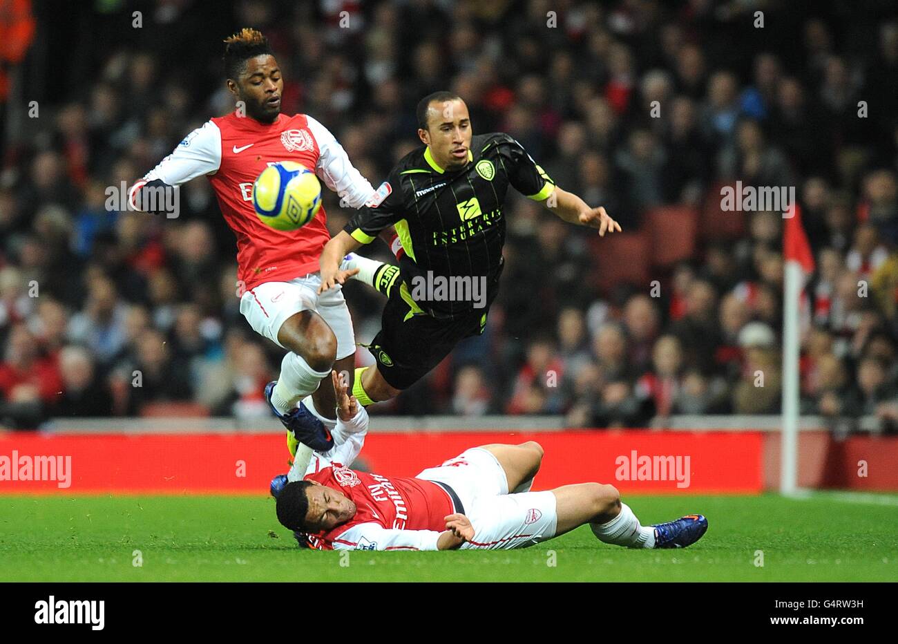 Arsenal's Francis Coquelin and Alex Song (left) battle for the ball with Leeds United's Andros Townsend (centre) Stock Photo
