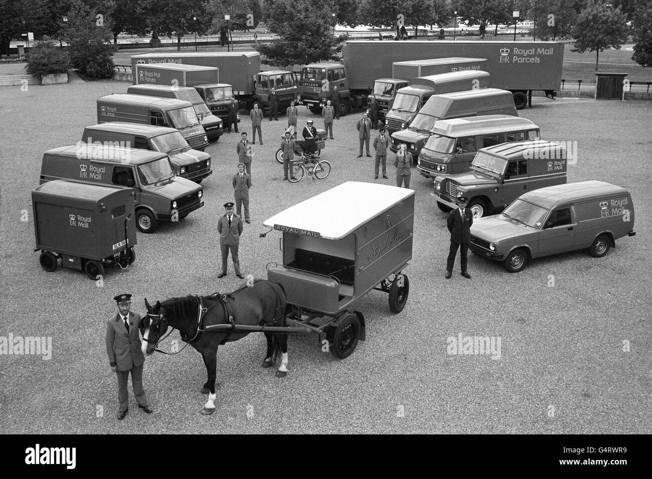 An example of every vehicle in the Royal Mail fleet lines up in London, arranged behind a horse-drawn mail wagon, last used in 1949. Stock Photo