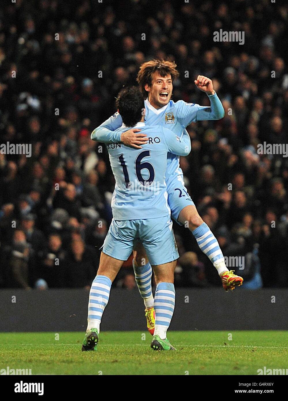 Manchester City's David Silva (right) celebrates after scoring the first goal with team mate Sergio Aguero (left) Stock Photo