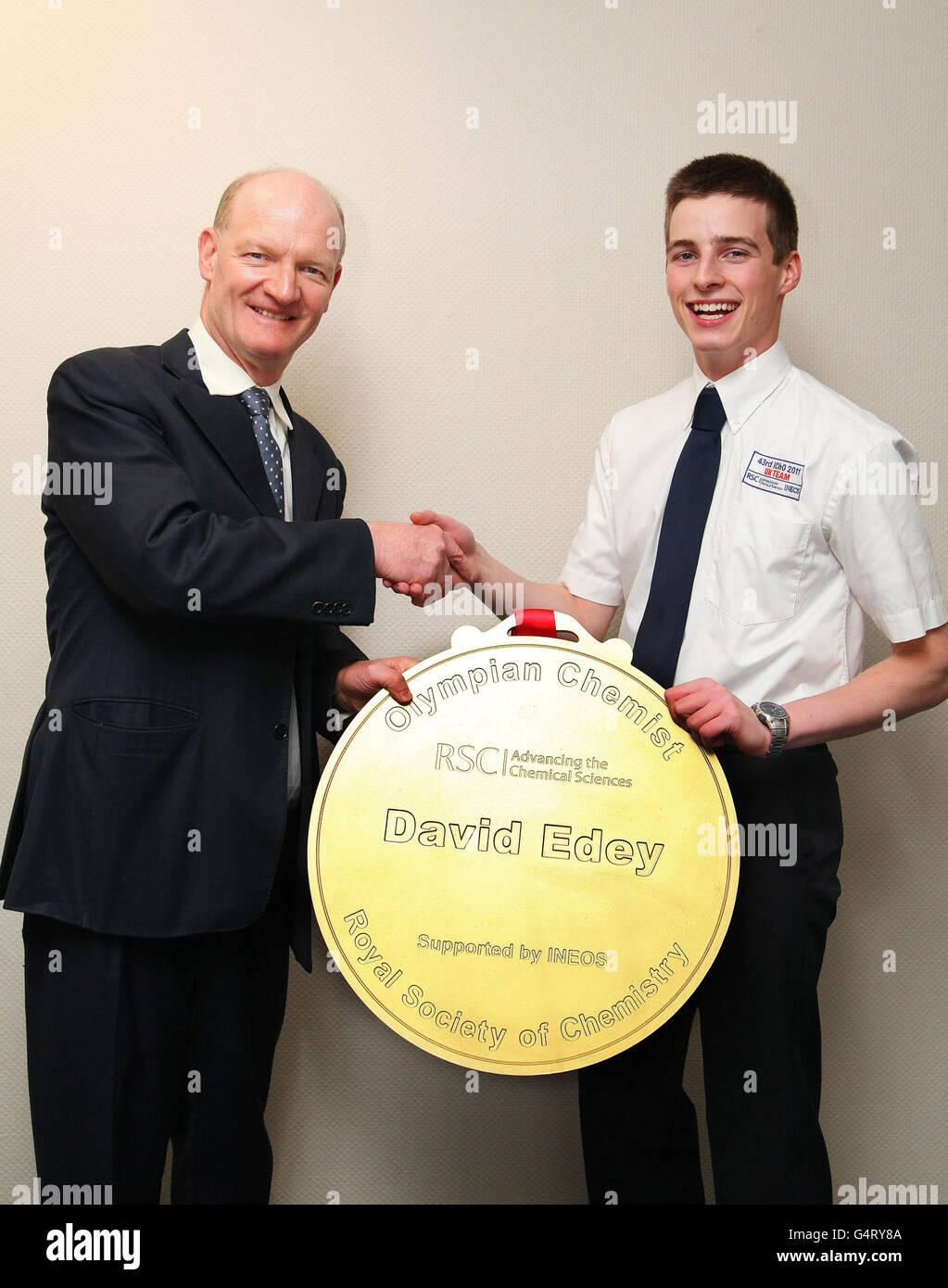 Science minister David Willetts (left) presents Olympian chemist David Edey with his Gold Medal Award for winning top prize at the 43rd International Chemistry Olympiad at the Department of Business, Innovation and Skills in London. Stock Photo