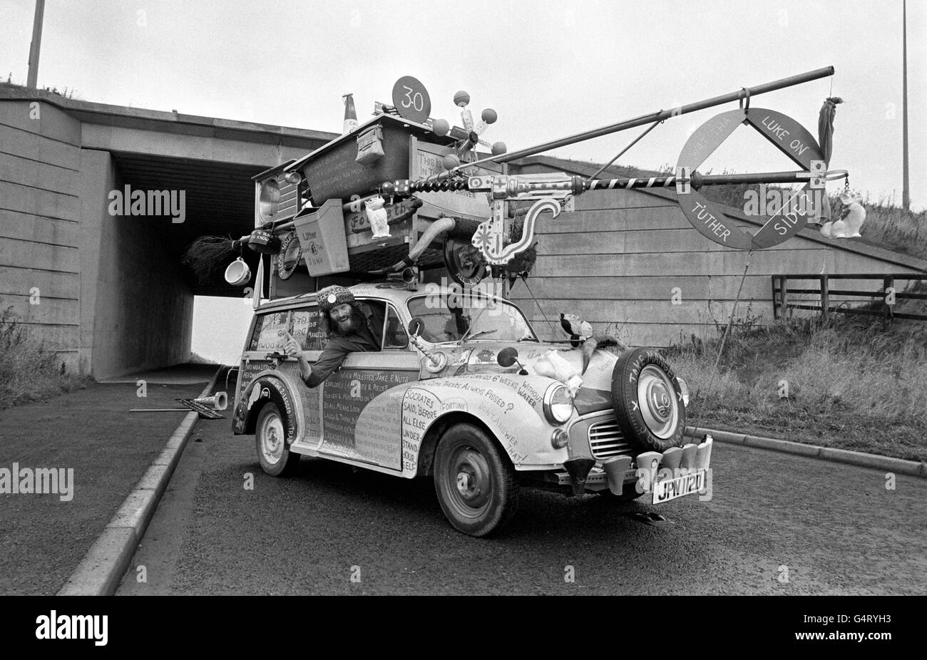 Jake Mangel Wurzel and his incredible Wurzel-Wagon. Just about every thing he owns is piled on top of the Morris 1000 Traveller Estate. Jake, a former lorry driver, born John Grey, changed his name by deed poll when he appointed himself Huddersfield's unpaid entertainer. Stock Photo