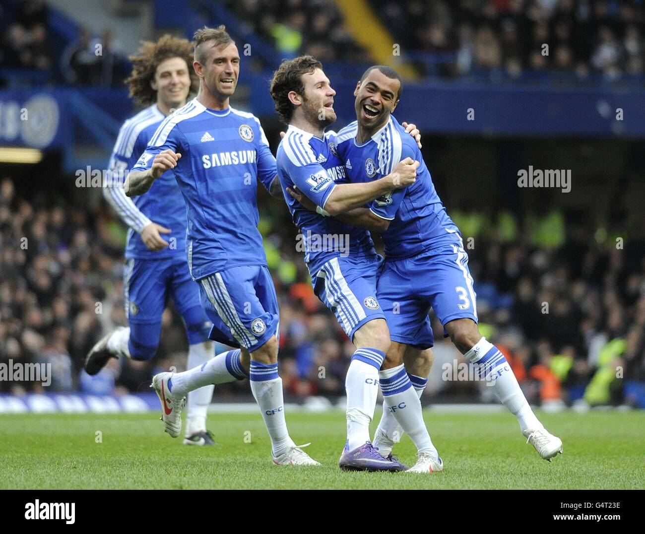 Soccer - Barclays Premier League - Chelsea v Fulham - Stamford Bridge. Chelsea's Juan Mata (2nd right) celebrates with his team mate Ashley Cole (right) after scoring the first goal of the game Stock Photo