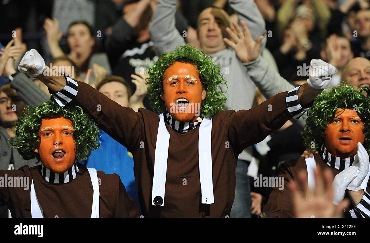 Soccer - Barclays Premier League - Bolton Wanderers v Newcastle United - Reebok Stadium. Newcastle United fans dressed as Umpa Lumpas celebrate in the stands Stock Photo