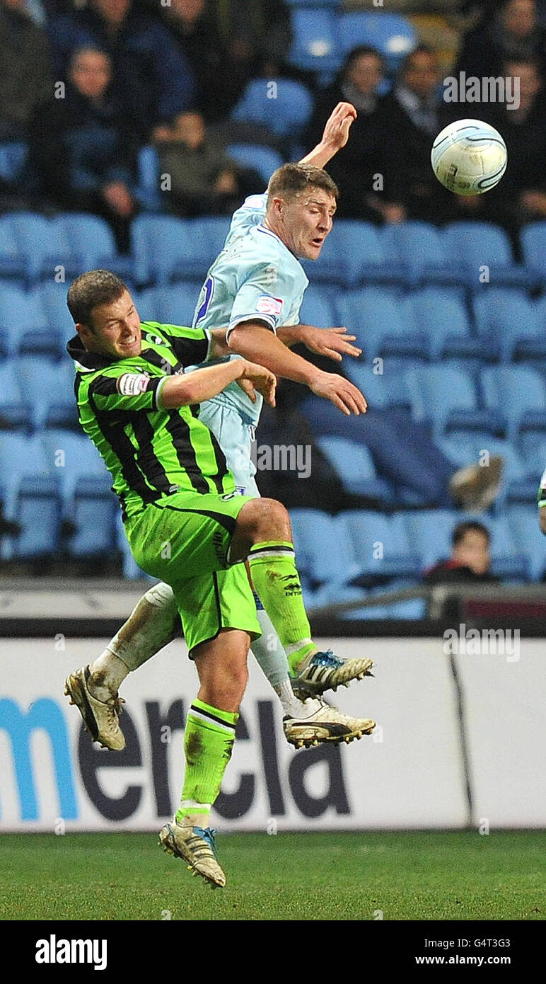 Coventry City's Gary Deegan and Brighton & Hove Albion's Jake Caskey-Foster jump for the ball during the npower Championship match at the Ricoh Arena, Coventry. Stock Photo