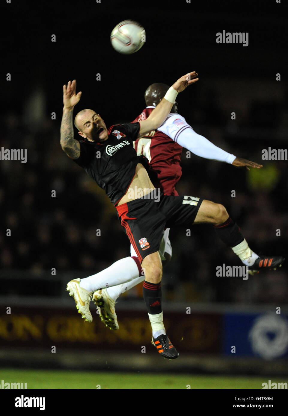 Soccer - npower Football League Two - Northampton Town v Swindon Town - Sixfields Stadium. Northampton Town's Adebayo Akinfenwa and Swindon Town's Alan McCormack during the npower League Two match at Sixfields Stadium, Northampton. Stock Photo