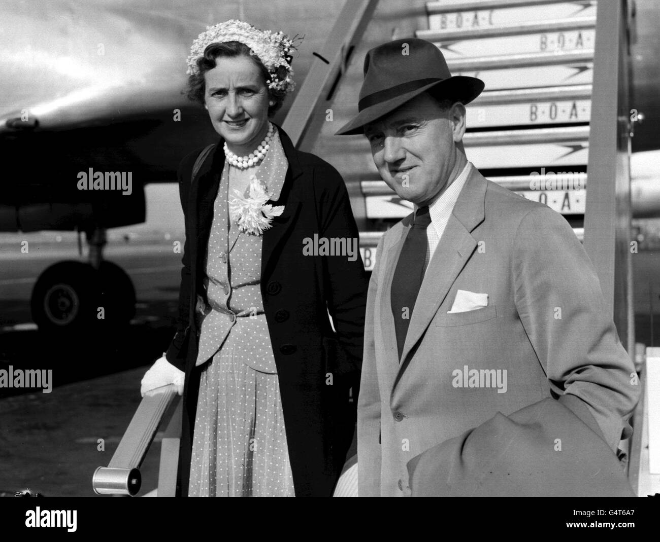 Sir Robert Brown Black, new Governor and Commander-in-Chief of Singapore with his wife, at London Airport as they left by BOAC liner for Singapore. Stock Photo
