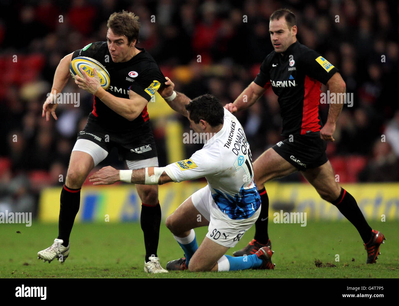 Saracens Chris Wyles is tackled by Bath's Stephen Donald during the Aviva Premiership match at Vicarage Road, Watford. Stock Photo