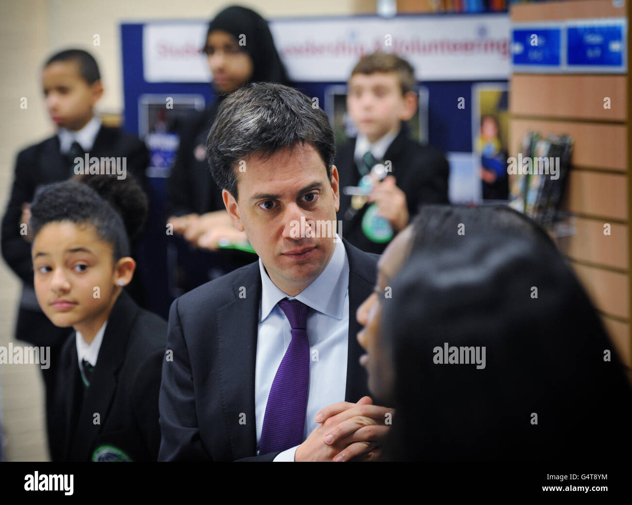 Labour leader Ed Miliband meets pupils at Bethnal Green Academy in east London before delivering a speech on the economy. Stock Photo