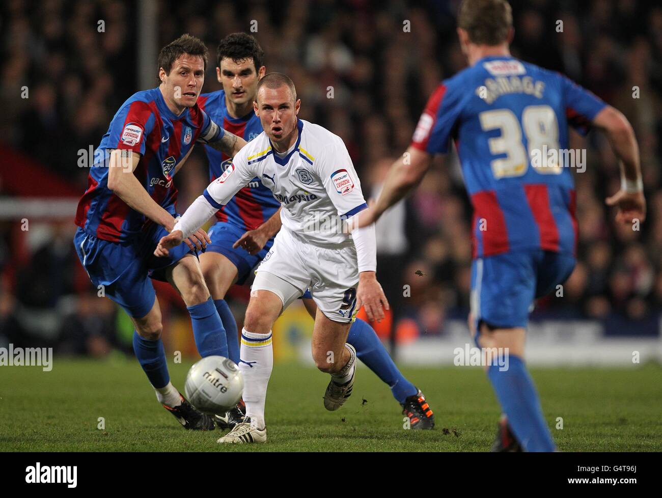 Cardiff City's Kenny Miller (9) gets away from Crystal Palace's Patrick McCarthy (left) before meeting Peter Ramage (right) Stock Photo