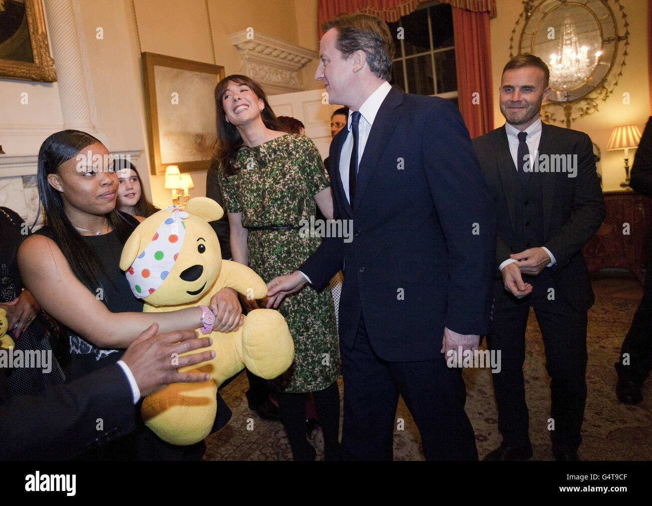 Prime Minister David Cameron, wife Samantha, second left, and singer Gary Barlow, right, meet guests during a reception at 10 Downing street for supporters and beneficiaries of the BBC's Children in Need charity. Stock Photo