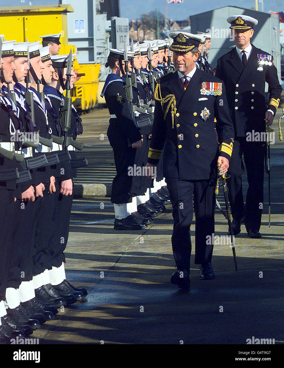The Prince of Wales inspects a 220-strong guard of honour during a visit to Portsmouth Navy base where he honoured 87 warships by presenting them with a Queen's Colour. * Charles presented colours to the surface flotilla, comprising all the Navy's surface ships, stationed at Portsmouth and Plymouth bases and in Scotland and carrying about 12,000 servicemen and women. Stock Photo