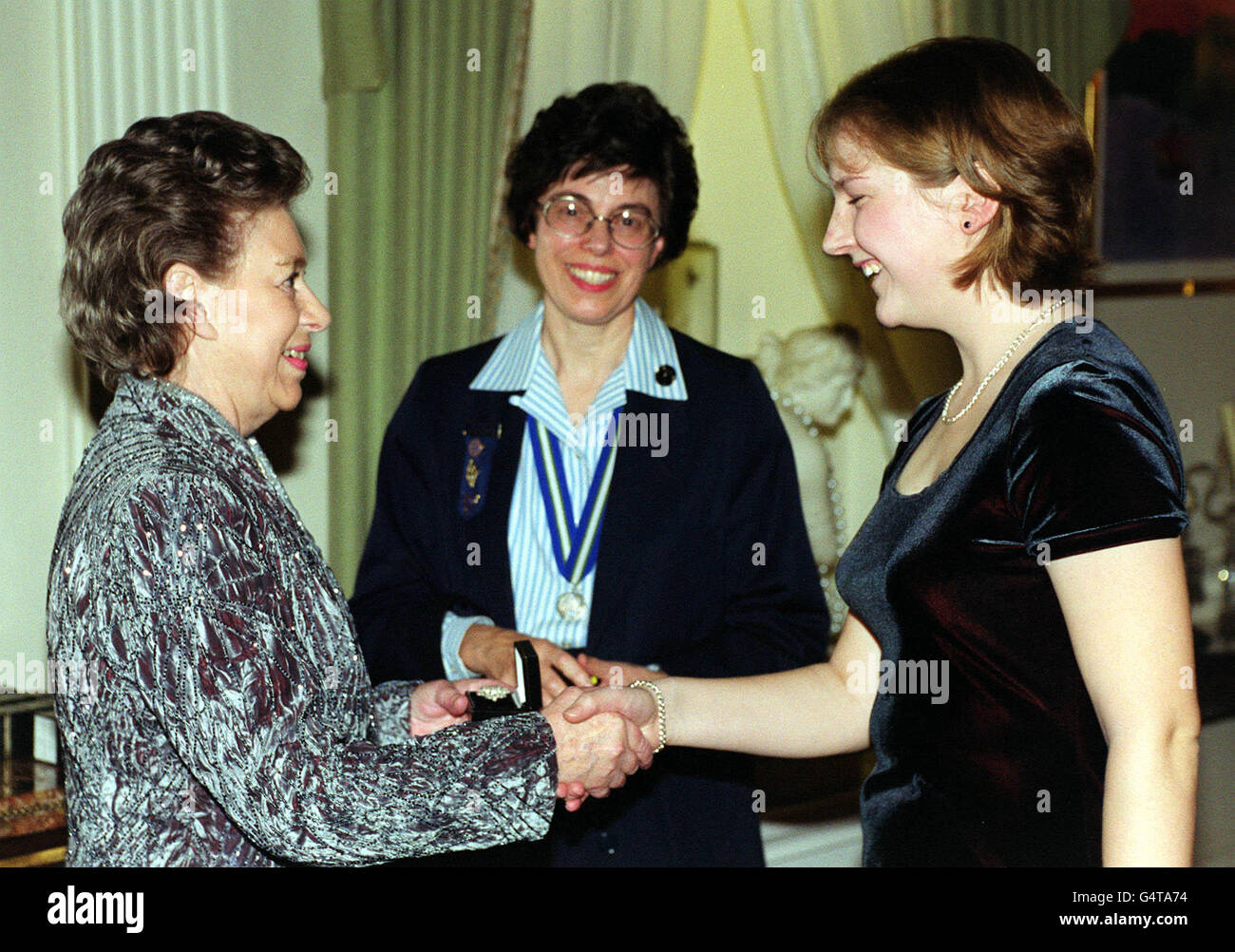 Princess Margaret, sister to Britain's Queen Elizabeth II, was visited at Kensington Palace by members of the Girl Guides Association. HRH presented a badge chosen by a group , to mark the Millennium. * Part of the revenue raised from the sale of the badges will support the Book Aid Service project, benefiting child literacy in Africa. (l/r) Princess Margaret, Bridget Towle, Chief Guide, Naomi Giddings, from Royston, Anglia. Stock Photo