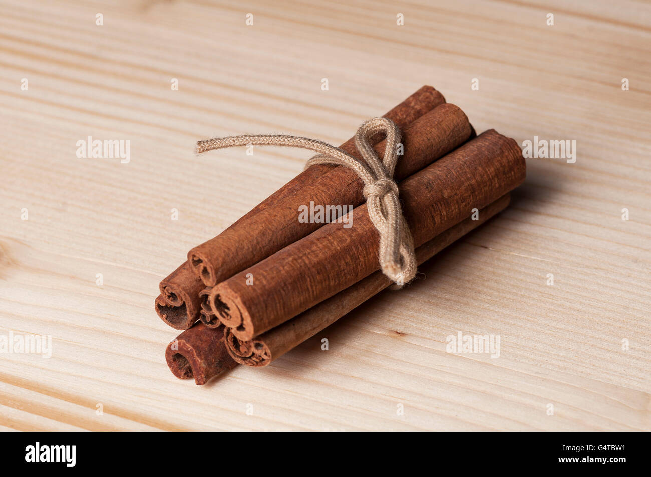 Close-up of cinnamon sticks on a wooden table Stock Photo