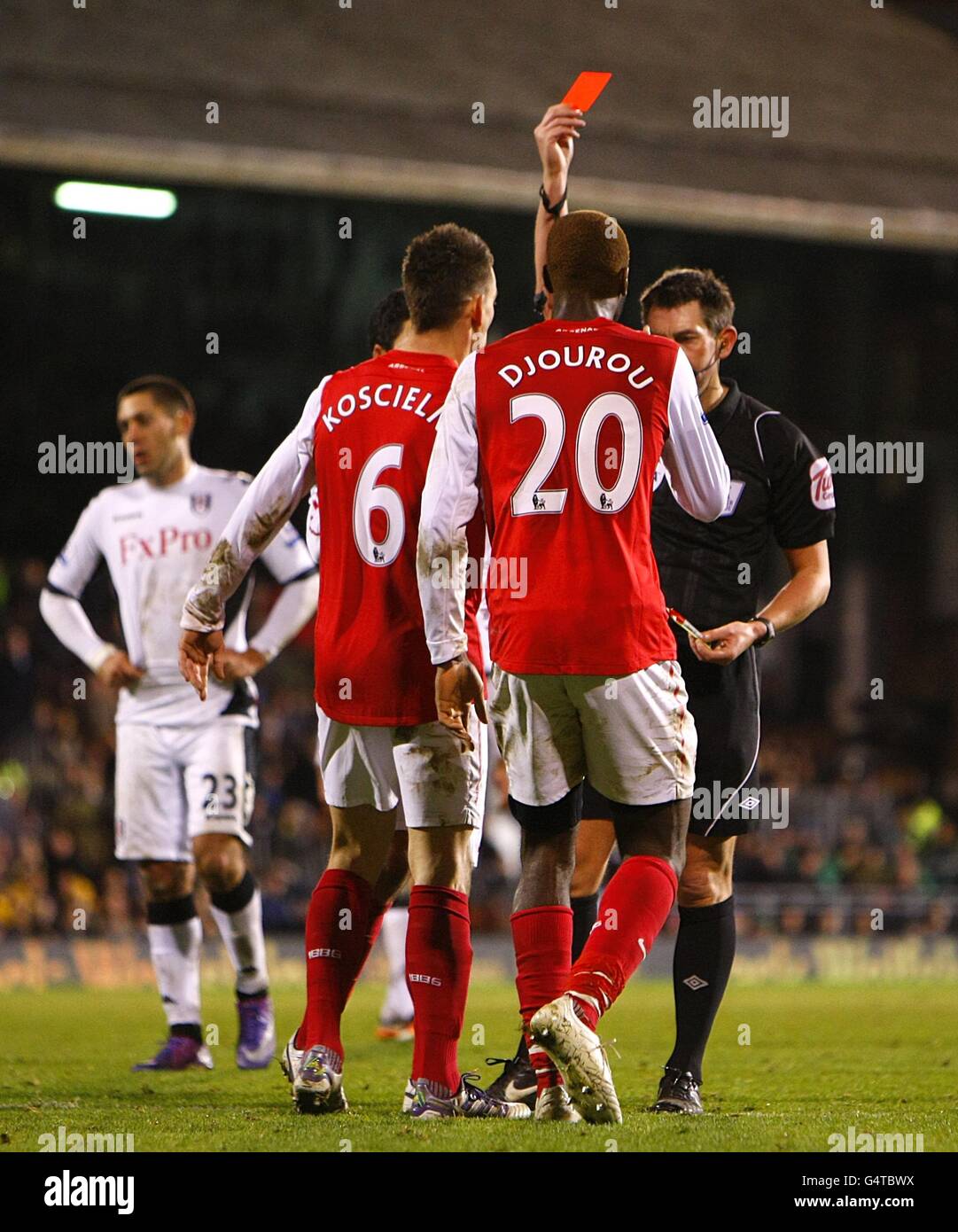 Soccer - Barclays Premier League - Fulham v Arsenal - Craven Cottage. Arsenal's Johan Djourou (20) is shown the red card by referee Lee Probert Stock Photo