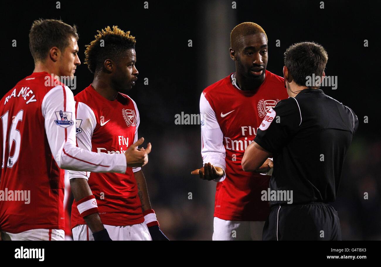 Arsenal's Johan Djourou (second right) complains to referee Lee Probert after being shown a red card Stock Photo