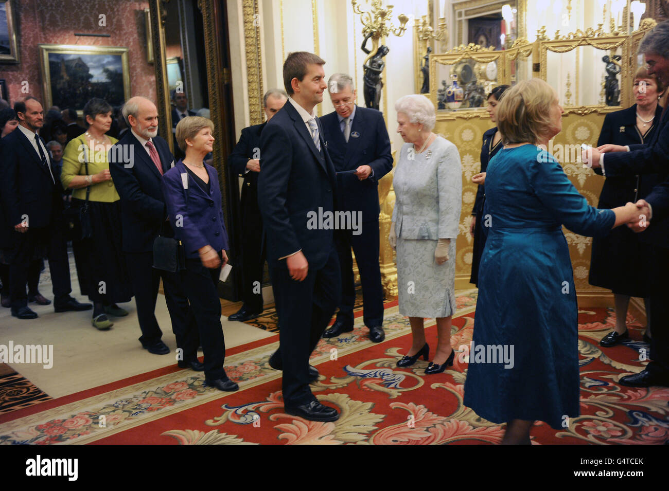 Queen Elizabeth II meets guests as the Queen and Duke of Edinburgh host a reception to celebrate exploration and adventure at Buckingham Palace, London. Stock Photo