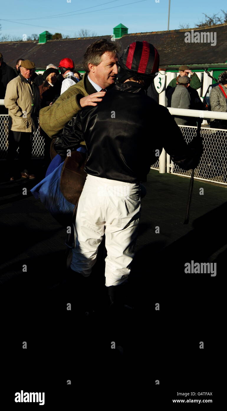 Trainer of Creekside John Ferguson congratulates his jockey Jack Quinlan in the winner's enclosure after winning The yorkshire-outdoors.co.uk juvenile maiden hurdle race Stock Photo