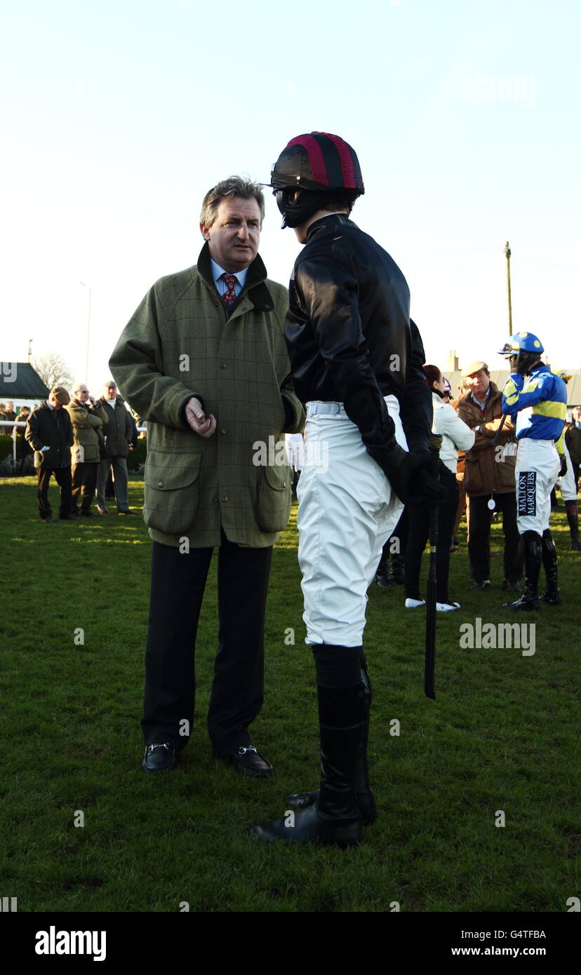 Horse Racing - Catterick Bridge. Trainer John Ferguson chats with his jockey Jack Quinlan before he rides Cry of Freedom in The catterickbridge.co.uk novices' hurdle race Stock Photo