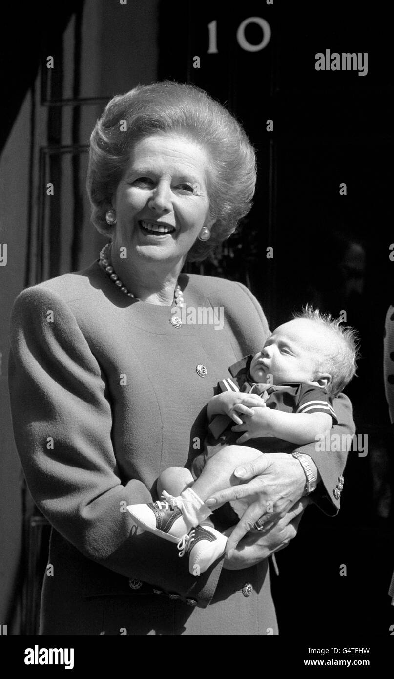 Prime Minister Margaret Thatcher cradles her two month old grandson, Michael, for the first time outside 10 Downing Street, London. Stock Photo