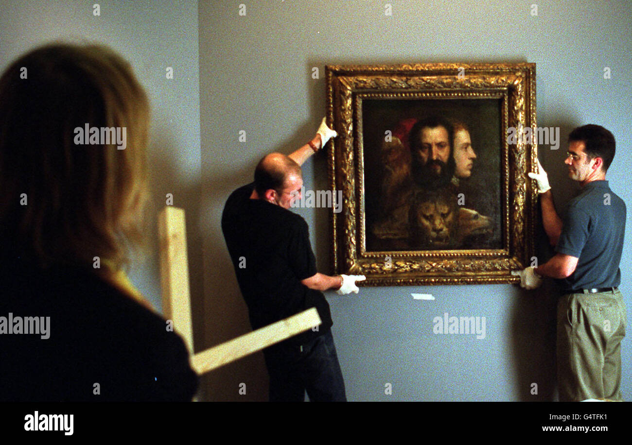 Assistants at the National Maritime Museum at Greenwich, perform the delicate task of installing 'Allegory of Prudence' by Titian (on loan from the National Gallery), under the watchful eye of curator Dr Kristen Lippincott. * The Titian forms part of The Story of Time exhibition at the Queen's House which opens on December 1st. Stock Photo