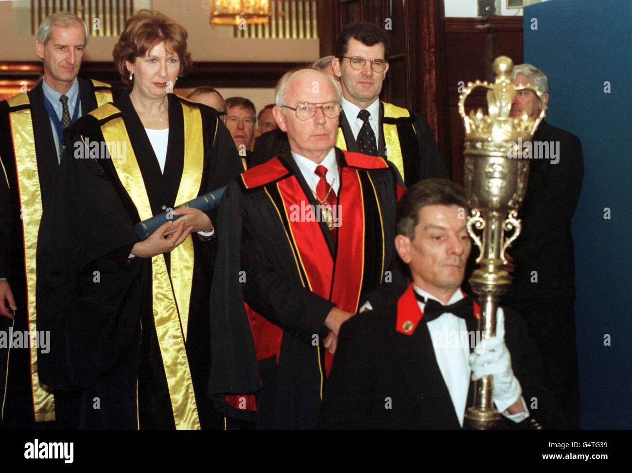 President of the Republic of Ireland, Mary McAleese (left) is escorted away by the President of the Royal College of Physicians & Surgeons of Glasgow Mr Colin MacKay (centre) after receiving an honourary fellowship of the college at a ceremony in Glasgow. Stock Photo