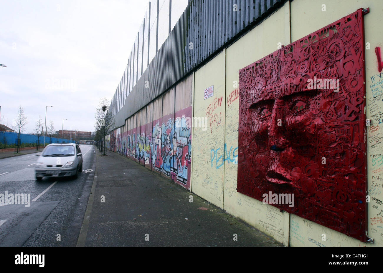 The largest peace wall in Belfast, at Cupar Way, which separates the Catholic Falls area and the Protestant Shankill area of the city. Stock Photo