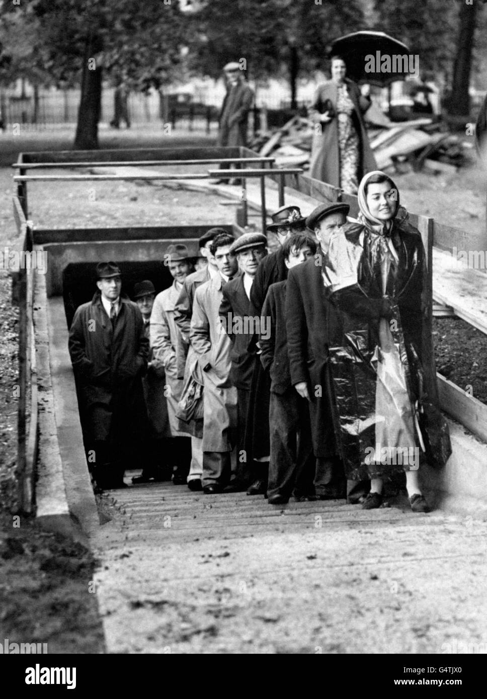 Civilians emerge emerge from part of a four mile long air raid shelter into a London park in 1939. Stock Photo