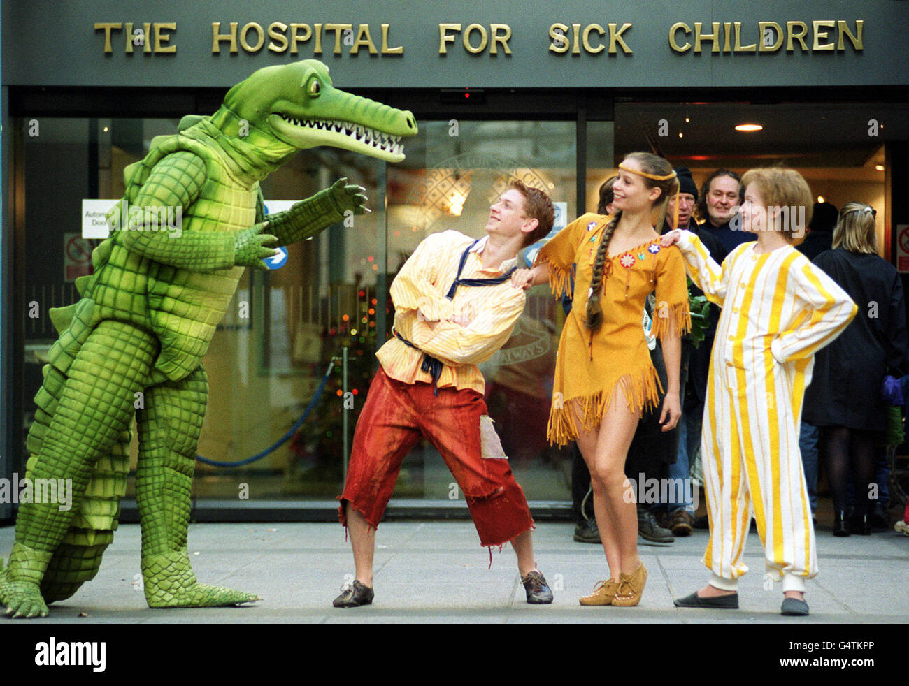 Cast members from the Atlanta Ballet production company outside Great Ormond Street Children's Hospital, in London. The group visited the children in the costumes from the performance Peter Pan, which will be staged at the Royal festival Hall from December 21st 1999. * Actors Left-right, Croc, Steve Slater, Lost Boy, Robin Galdwin, Indian Maiden, Amy Lawson and Michael, Lainey Schilling. Stock Photo