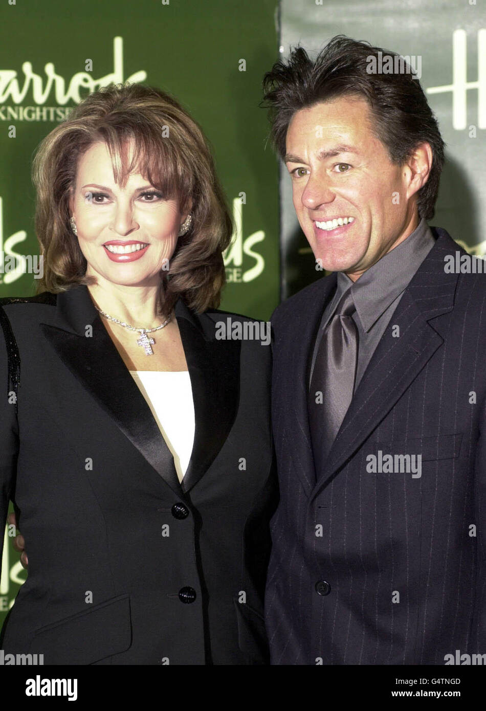 Hollywood film star Raquel Welch with her husband Richard Palmer pose for the media at Harrods, in Knightsbridge, London, after she opened the store's January sale. Stock Photo