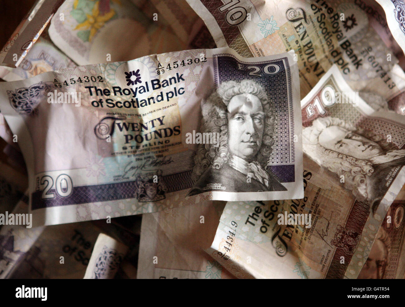 A general view of bank notes from the Royal Bank of Scotland in Edinburgh, as David Cameron was accused of a 'disgraceful failure of leadership' by Labour leader Ed Miliband after the chief executive of the majority taxpayer-owned Royal Bank of Scotland (RBS) was awarded a bonus in shares worth almost &pound;1 million. Stock Photo