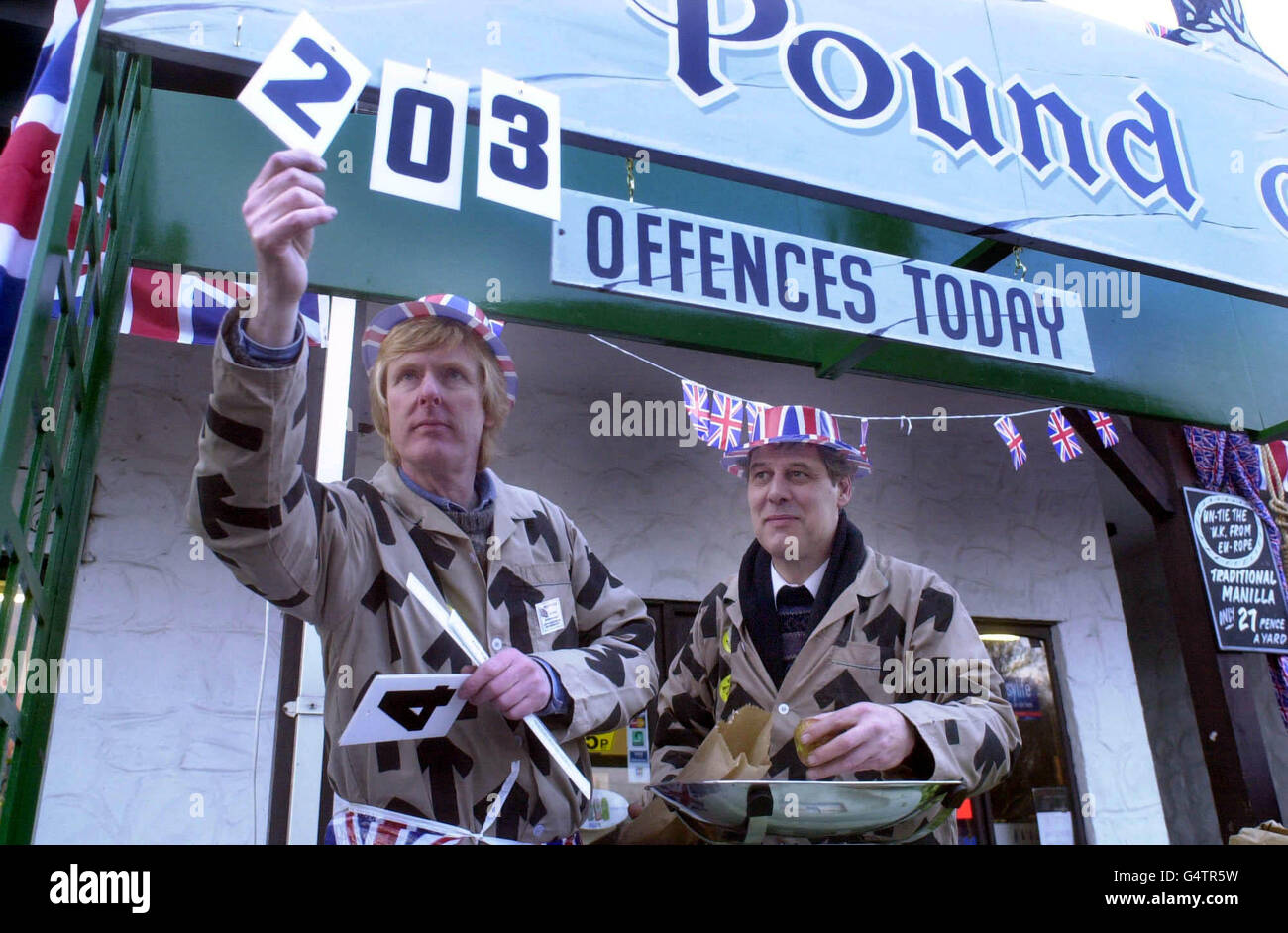 Bruce Robertson (left) Chairman of Trago Mills and Chairman British Weights and Measures Association with Dr Richard North the licensee of the 'Pound of Flesh' fruit and veg stall mark up sales on the stall at Trago Mills near Newton Abbot. Stock Photo