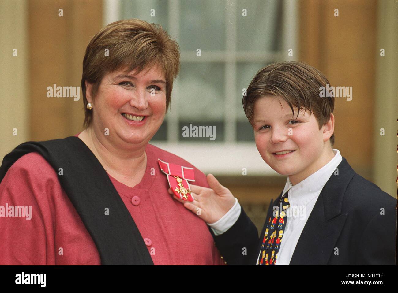 Jenni Murray presenter of BBC Radio Four Woman's Hour with her son Charlie  Forgham-Bailey after receiving an OBE for services to Radio Broadcasting  from the Queen during an Investiture ceremony at Buckingham