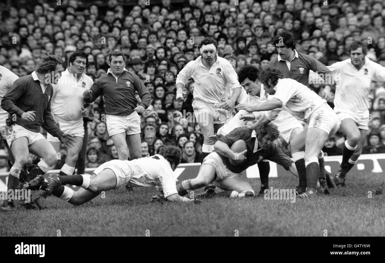 England converge on Graham Price of Wales after he was brought down by Michael Burton during a match at Twickenham. Players are (from left) Derek Quinnell, Barry Nelmes, Aubrey Faulkner, Bill Beaumont, Bob Mordell, Gerald davies (rear) and Michael Rafter. Stock Photo