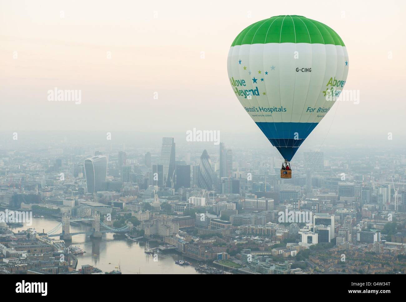 A hot air balloon flies past Tower Bridge and the City of London during
