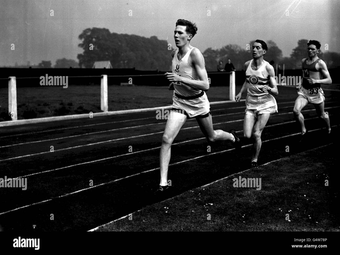 MARCH 23: On this day in 1929, Sir Roger Bannister was born. Bannister recently launched the new Royal Mint 50p coin to commemorate the 50th anniversary of his record-breaking sub four minute mile on May 6th 1954. Roger Bannister (front) represents Oxford University during the Inter-Varsity mile event at the white City in London Stock Photo