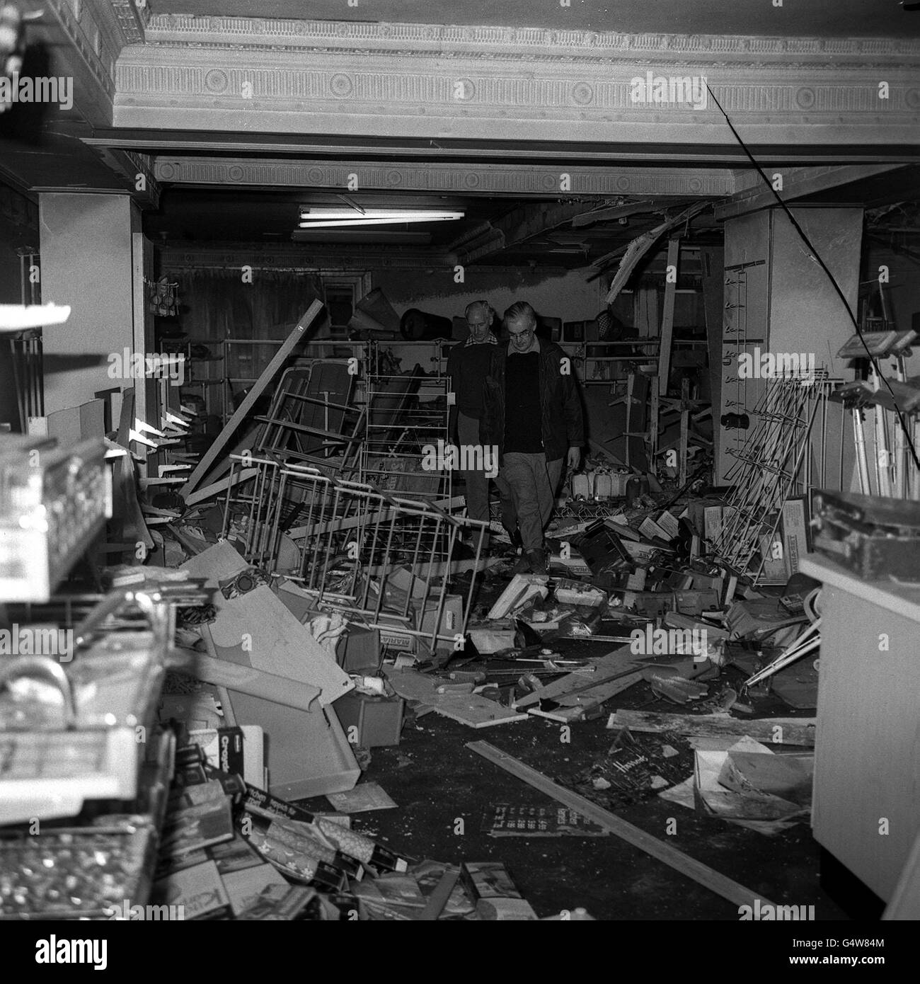 The damage inside Harrods to goods, fittings and the building itself after the 1974 bomb.. The managing director, Mr Robert Midgley (left) and general manager W.A. Craddock, tread carefully through the debris as they inspect the ruined departments. Stock Photo