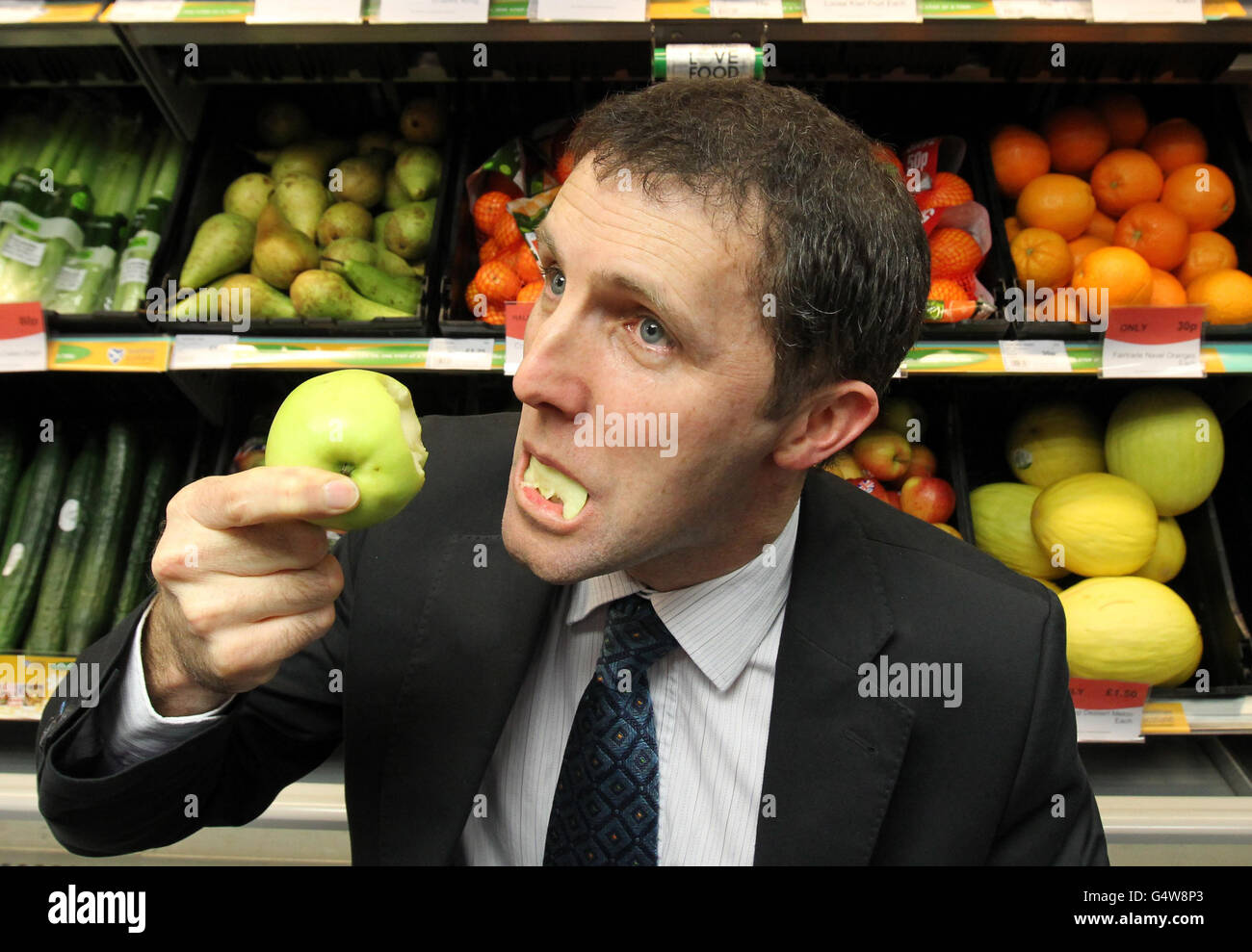 Public health minister Michael Matheson MSP eats an apple as he launches the Scottish Grocers Federation Healthy living programme at his local Scotmid co-operative store in Haggs near Bonnybridge. PRESS ASSOCIATION Photo. Picture date: Friday January 23, 2012. The aim of the campaign is to increase consumer awareness that healthy food is available within their local convenience stores. Photo credit should read: Andrew Milligan/PA Wire Stock Photo