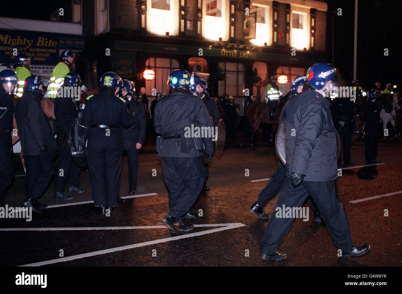 Police riot gear standby outside an East London pub, the Litter Driver, in Bow, which has been occupied by a group of skinheads. Stock Photo