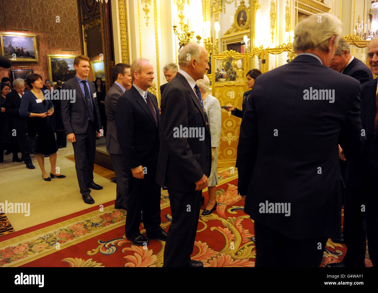 Queen Elizabeth II meets guests as the Queen and Duke of Edinburgh host a reception to celebrate exploration and adventure at Buckingham Palace, London. Stock Photo