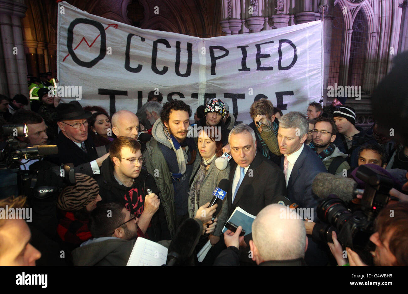 Occupy London protesters, with John Cooper QC, blue tie, and barrister Michael Paget, pink tie, at the High Court following news that the City of London Corporation has won its High Court bid to evict anti-capitalist protesters from outside St Paul's Cathedral. Stock Photo