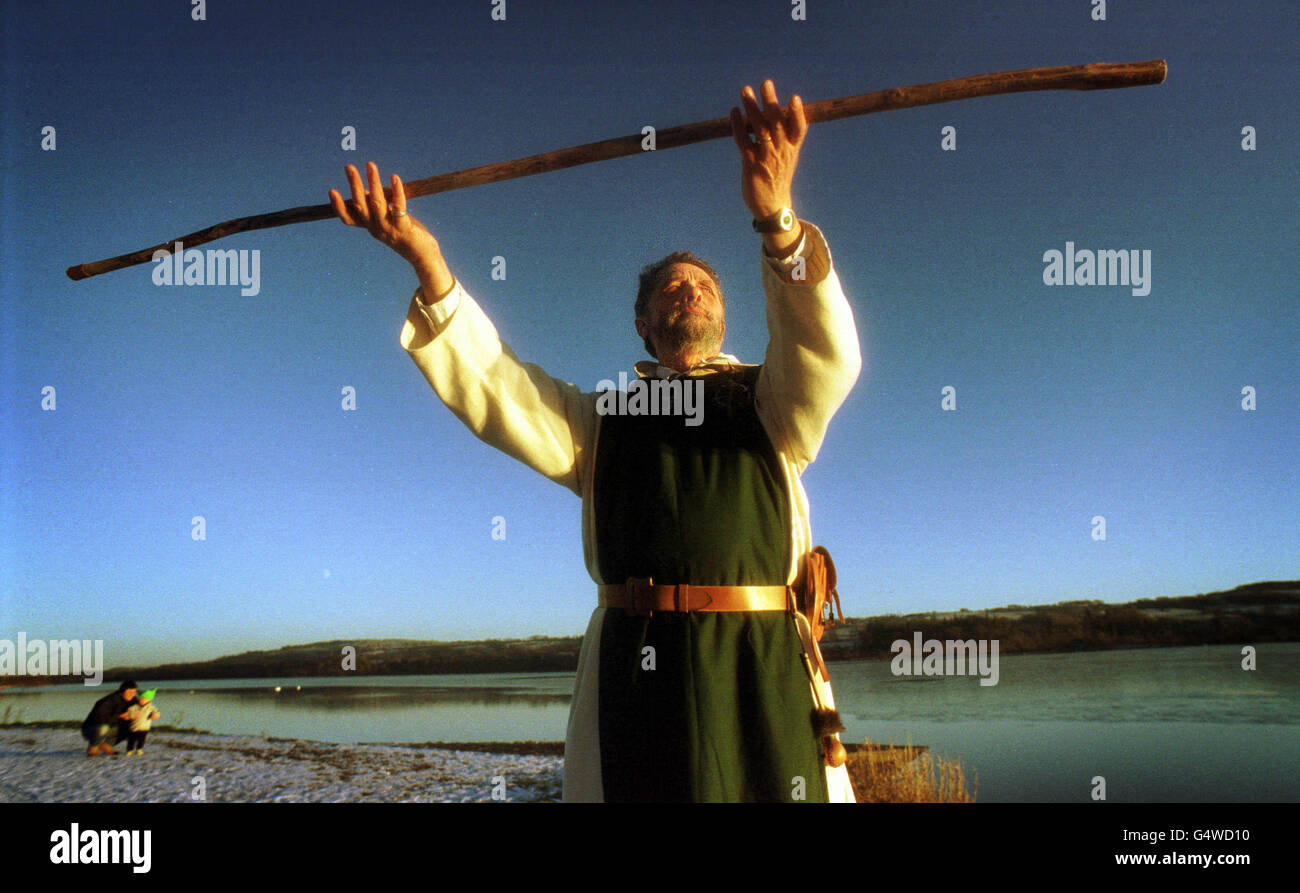 Druid Chris Turner from Ardrossan gazes up towards the setting winter sun as he celebrates the near-forgotten pagan festival of yule, which is due to take place in two days time on the winter solstice, at the Clyde Muirshiel country park in Scotland. * As non-christians Druids do not celebrate Christmas but instead observe the old period of yule which they consider 'the dying of the sun and the rebirth of the sun as the child of light'. Stock Photo