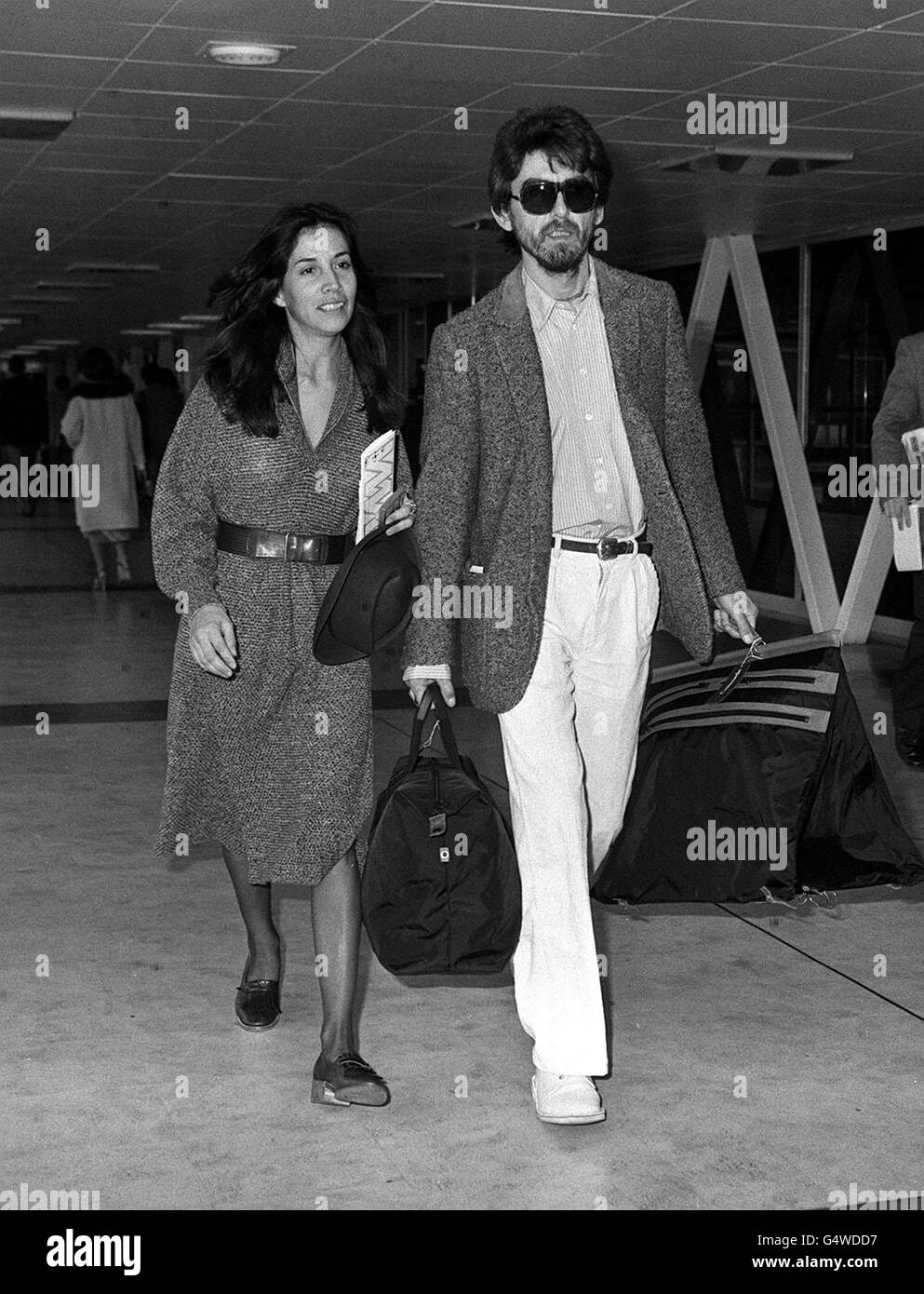 Former Beatle George Harrison and his Mexican wife Olivia at Heathrow Airport, London, before their flight to New York. ghgal Stock Photo