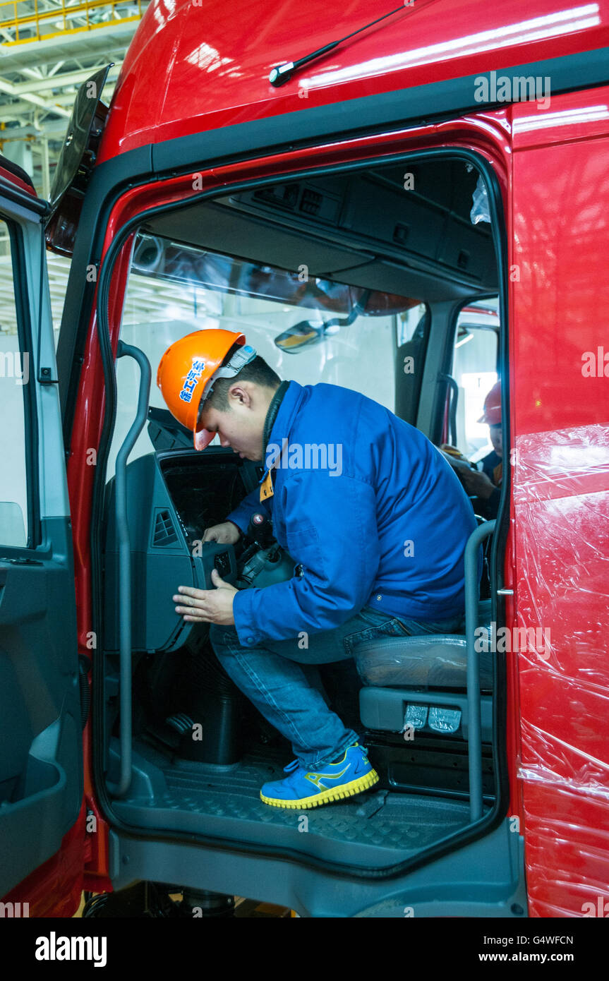 Workers assembling the cab of a Hanvan truck at the XCMG factory in Xuzhou, China. Stock Photo