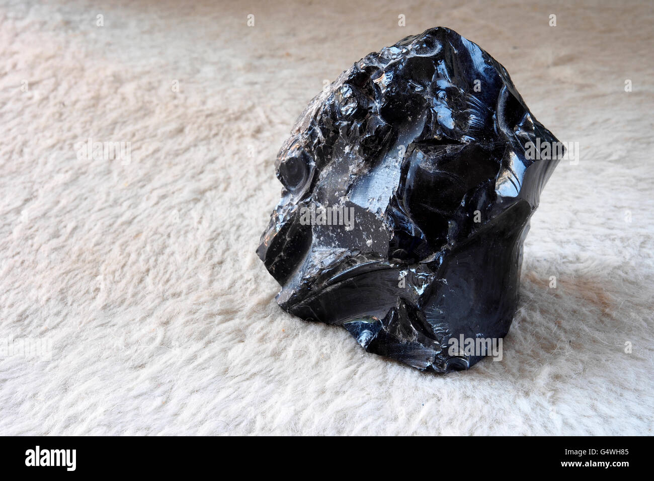 Obsidian stone from a free beach of the Lipari island , one of the Aeolian Islands in Sicily, Italy. Stock Photo