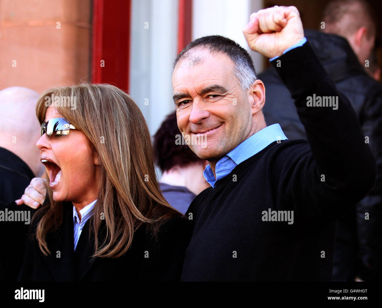 Former MSP Tommy Sheridan accompanied by his wife Gail, salutes well wishers as he arrives home in Glasgow after leaving Castle Huntly Prison,near Dundee, after serving just over one year of his three-year sentence for lying under oath. Stock Photo